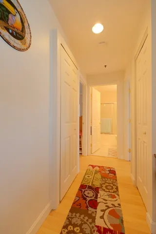 a hallway with a furniture and a rug