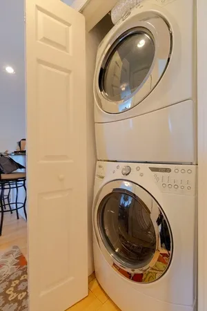 a living room with furniture and floor to ceiling window