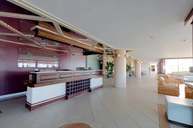 a view of a living room with kitchen
