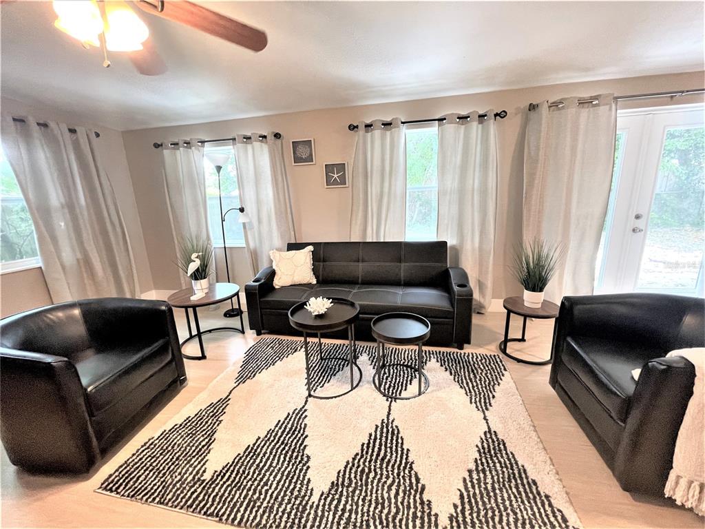 5106 104th Street North St. Petersburg, FL 33708 - Photo 12 of 35 a living room with furniture and a rug
