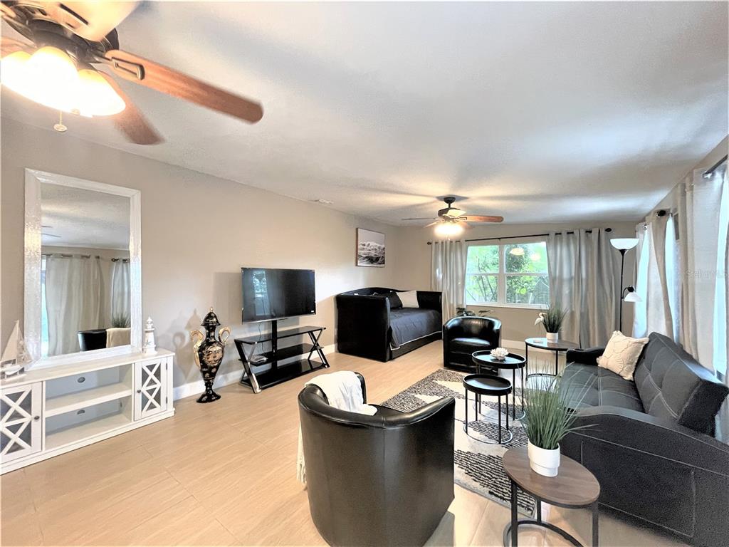 5106 104th Street North St. Petersburg, FL 33708 - Photo 13 of 35 a living room with furniture and a flat screen tv