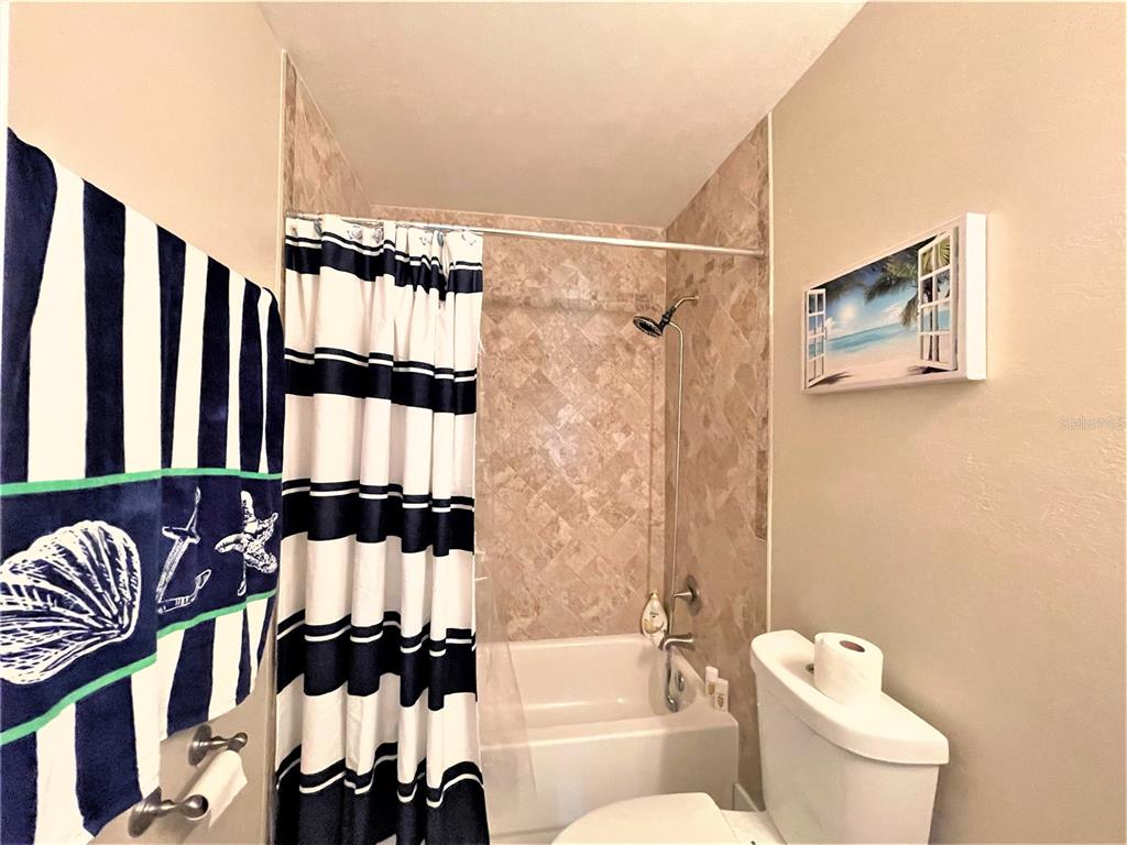 5106 104th Street North St. Petersburg, FL 33708 - Photo 21 of 35 a bathroom with a toilet and a shower