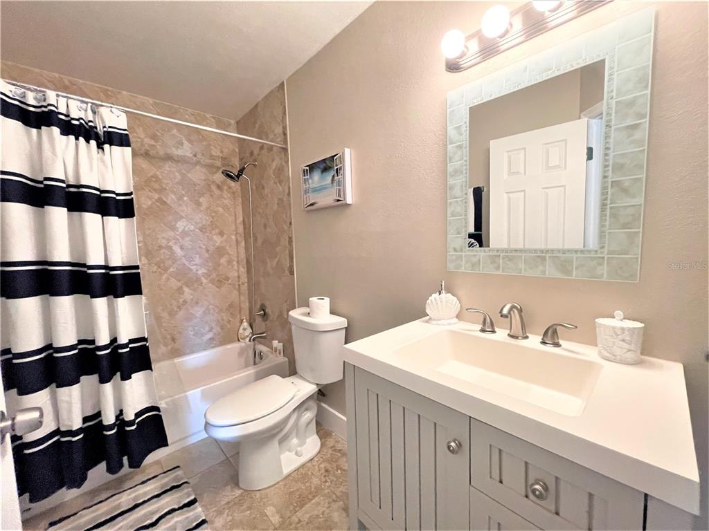 5106 104th Street North St. Petersburg, FL 33708 - Photo 22 of 35 a bathroom with a sink a toilet and shower