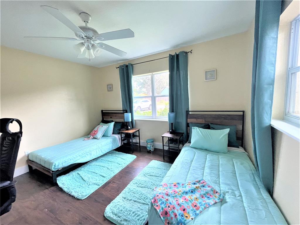 5106 104th Street North St. Petersburg, FL 33708 - Photo 24 of 35 a bedroom with a bed and a chandelier