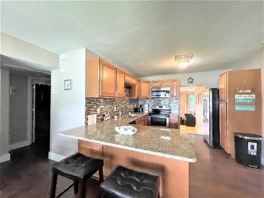 5106 104th Street North St. Petersburg, FL 33708 - Photo 3 of 35 a kitchen with a refrigerator and a counter top space