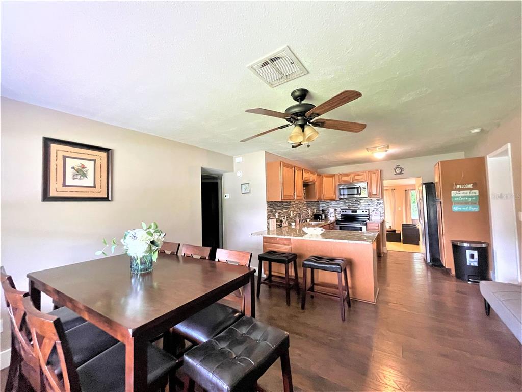 5106 104th Street North St. Petersburg, FL 33708 - Photo 6 of 35 a view of a dining room with furniture and wooden floor
