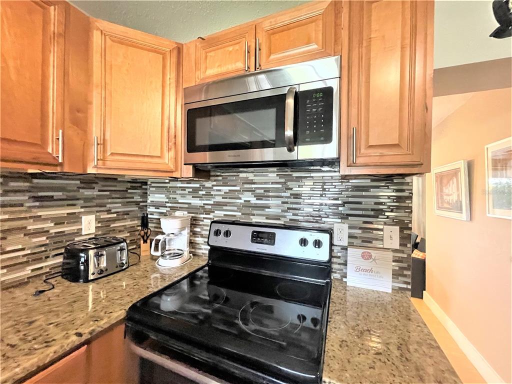 5106 104th Street North St. Petersburg, FL 33708 - Photo 9 of 35 a kitchen with a stove and a microwave