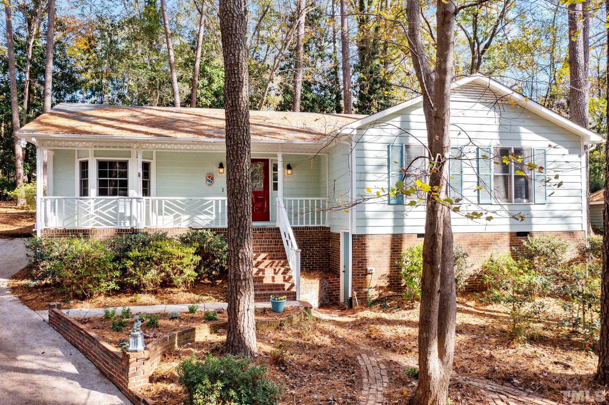 805 Nuttree Place Raleigh, NC 27606 - Photo 1 of 34 a front view of a house with a yard