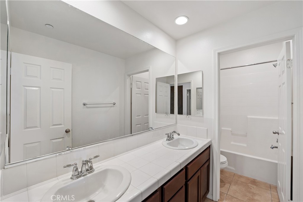 3108 North Oxnard Boulevard Oxnard, CA 93036 - Photo 18 of 40 a bathroom with a sink double vanity granite tub shower and a mirror