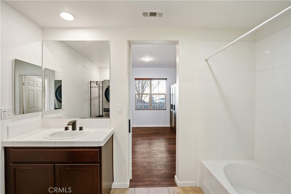 3108 North Oxnard Boulevard Oxnard, CA 93036 - Photo 35 of 40 a bathroom with a sink a mirror and a bathtub