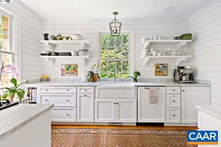 123 Cameron Lane Charlottesville, VA 22903 - Photo 13 of 43 a white kitchen with a stove a sink and a potted plant