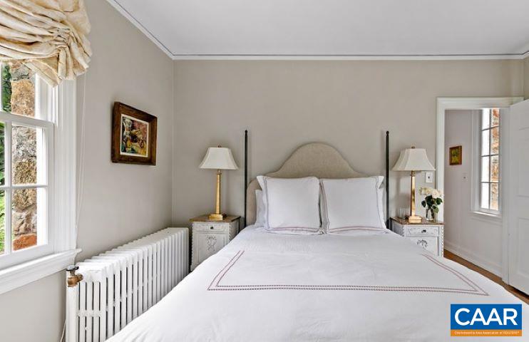 123 Cameron Lane Charlottesville, VA 22903 - Photo 18 of 43 a bedroom with a large bed and a chandelier