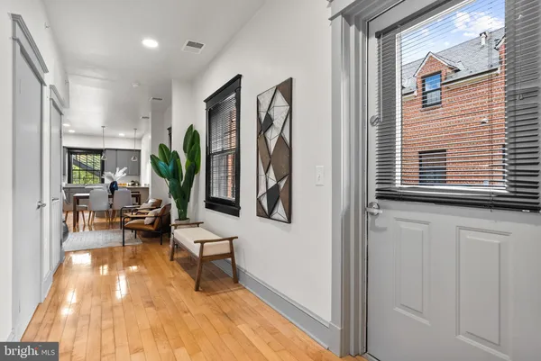 a view of a hallway with furniture and a entryway