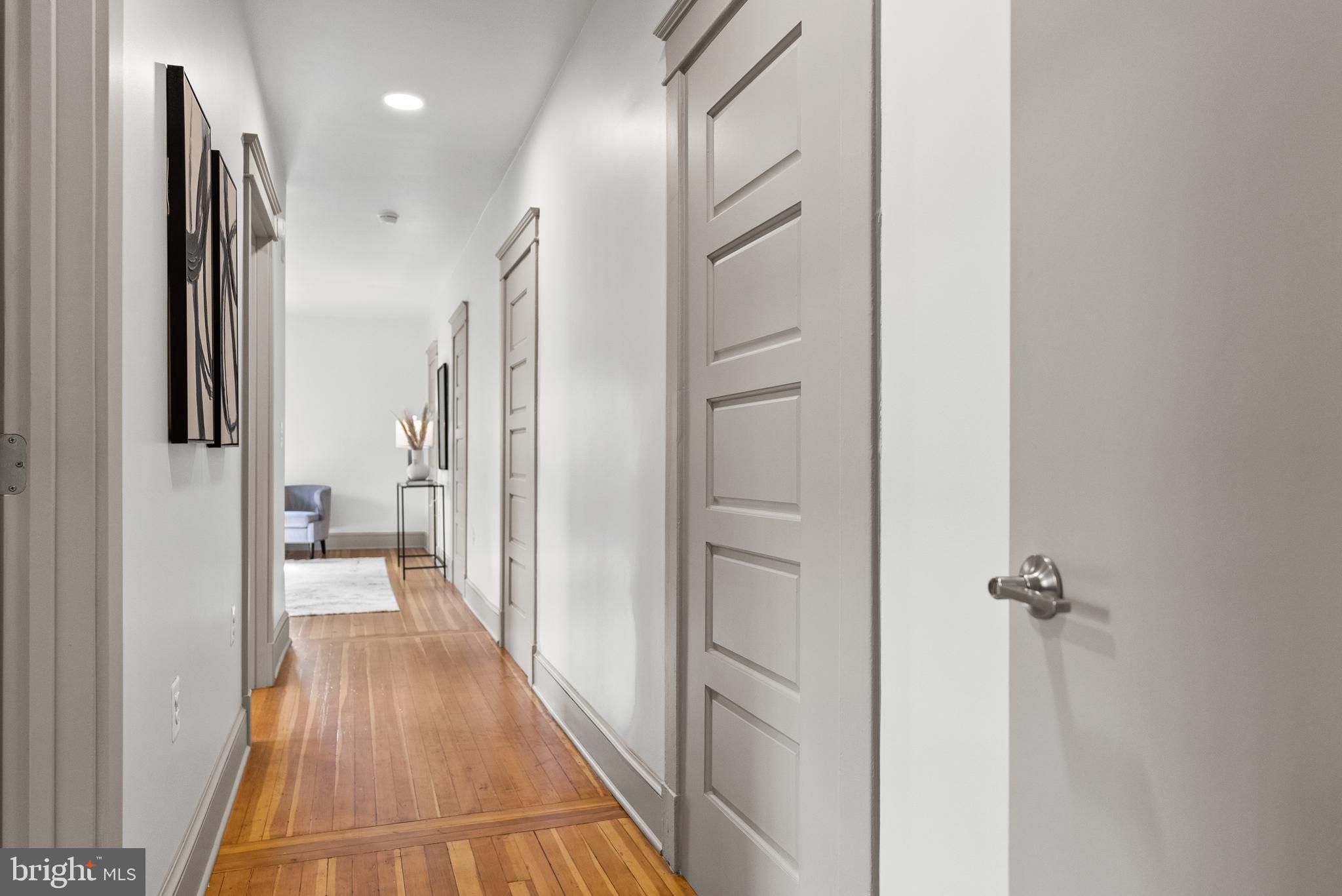 9071 Power House Road, Unit 102 Lorton, VA 22079 - Photo 26 of 50 a view of a hallway with wooden floor and a bathroom
