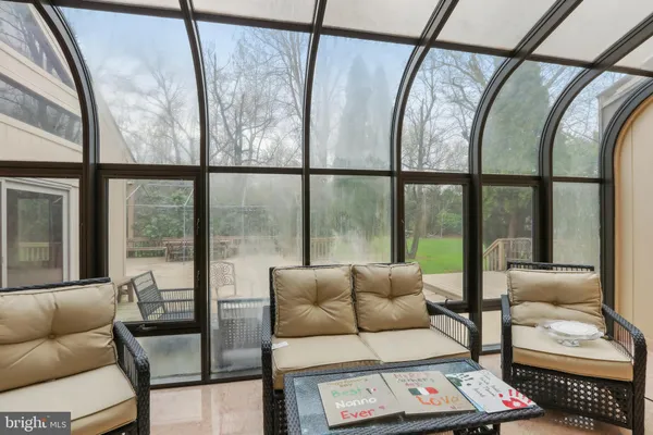a view of house with deck outdoor seating and covered with yard