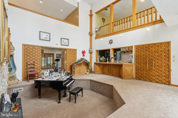 a living room with furniture a rug and a window