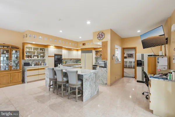 a view of a hallway with wooden floor and windows