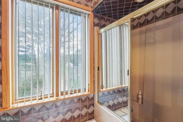 a bedroom with furniture and a large window