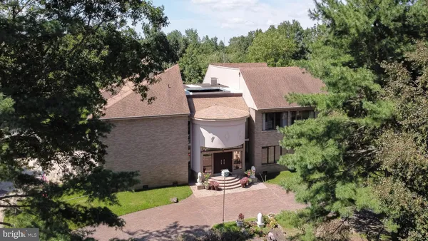 an aerial view of a house with a yard and lake view