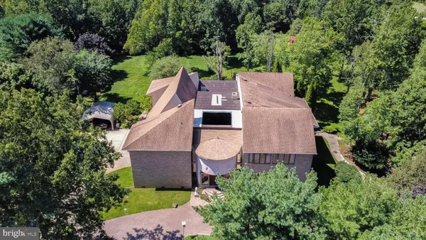 an aerial view of a house with a yard