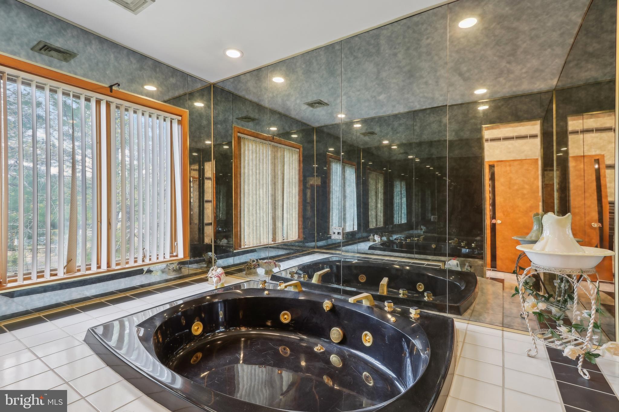 27 Cannon Range Road Milmay, NJ 08340 - Photo 79 of 95 a bathroom with a sink a large mirror and a bathtub
