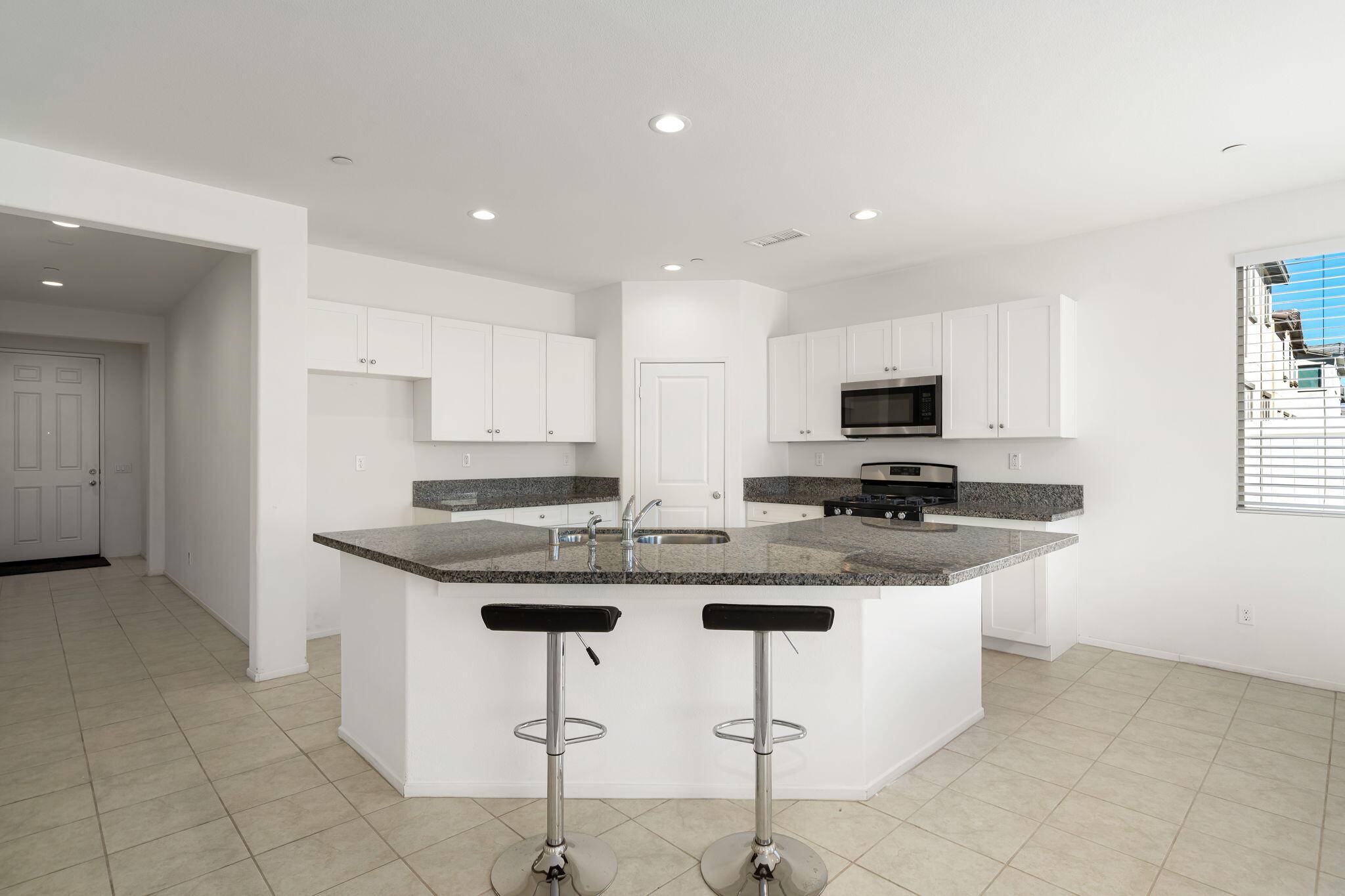 50252 Paseo Barcelona Coachella, CA 92236 - Photo 6 of 23 a kitchen with stainless steel appliances granite countertop a sink and a white cabinets