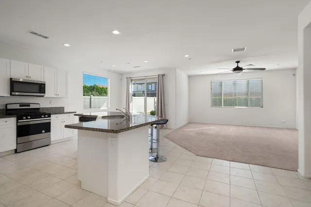 a kitchen with stainless steel appliances granite countertop a stove and a sink