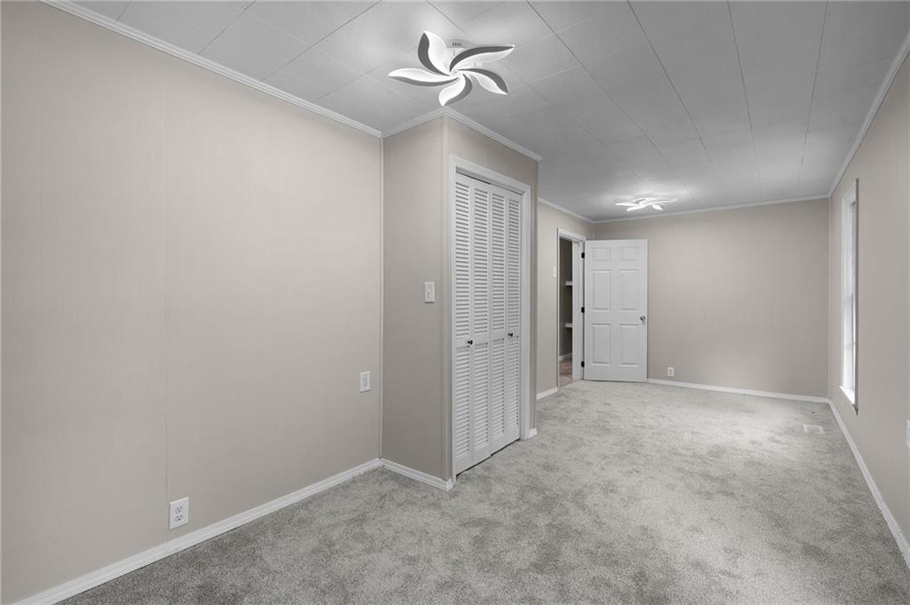 154 County Line Road Southwest Plainville, GA 30733 - Photo 20 of 27 an empty room with a ceiling fan and a window