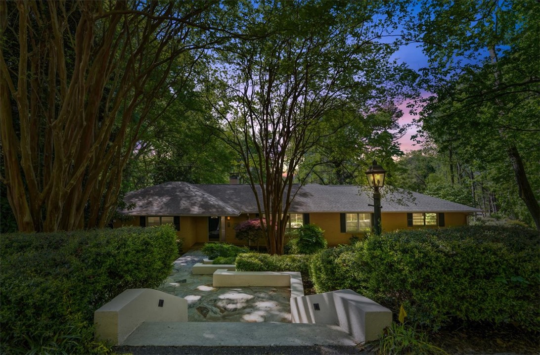 103 Satula Lane Clemson, SC 29631 - Photo 2 of 50 This charming home features a well-manicured yard and mature trees, creating a serene outdoor setting.
