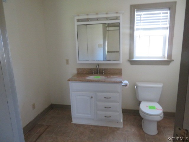 15212 Wilkinson Road Dinwiddie, VA 23841 - Photo 36 of 46 a bathroom with a granite countertop toilet sink and mirror