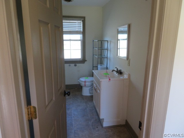 15212 Wilkinson Road Dinwiddie, VA 23841 - Photo 46 of 46 a bathroom with a sink and mirror with toilet