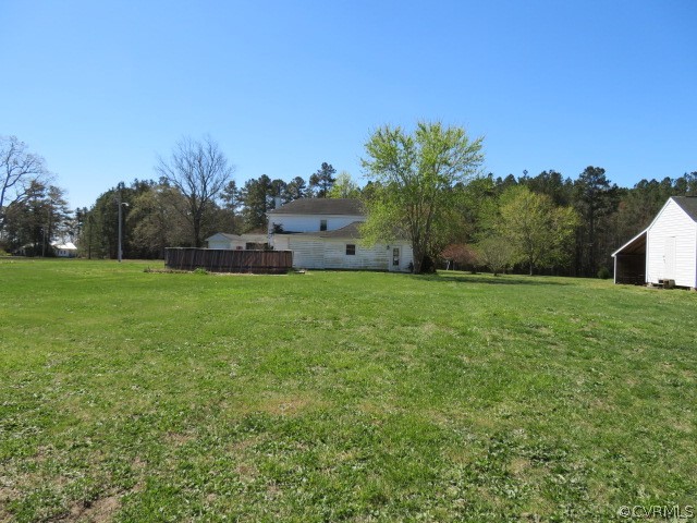 15212 Wilkinson Road Dinwiddie, VA 23841 - Photo 8 of 46 a house with green field in front of it