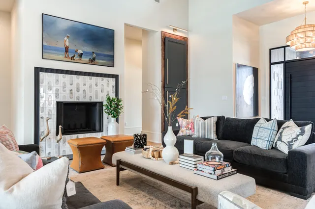 a kitchen with stainless steel appliances granite countertop a refrigerator a sink dishwasher a dining table and chairs with wooden floor