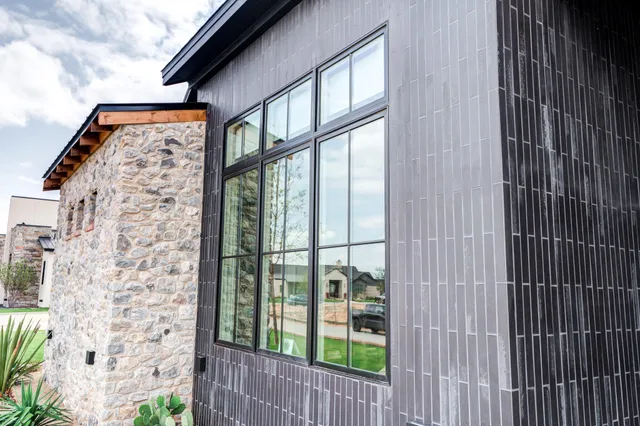 an aerial view of a house with a yard pool and outdoor seating