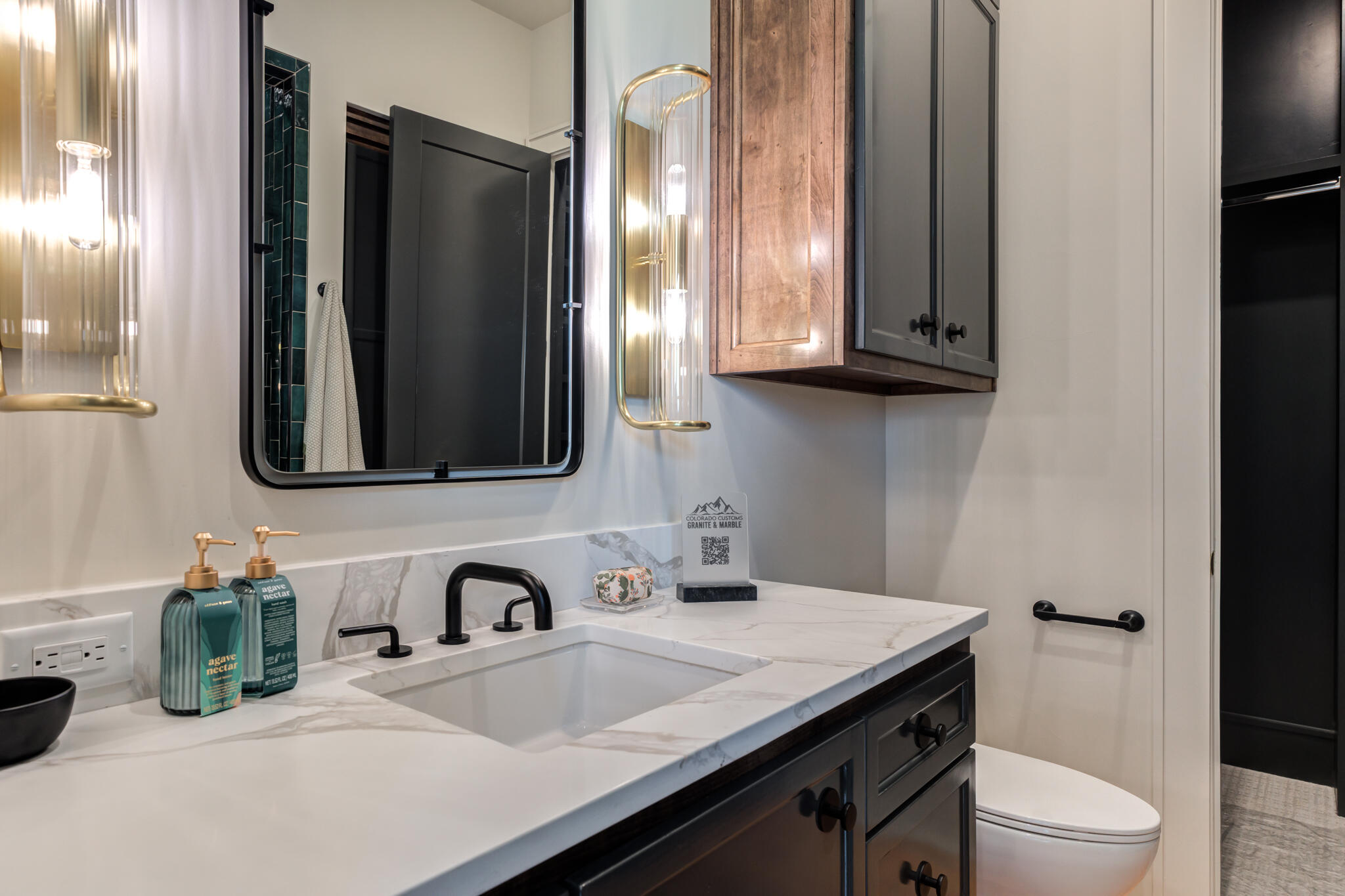4510 Zadar Avenue Lubbock, TX 79407 - Photo 99 of 142 a bathroom with a granite countertop sink a toilet and mirror