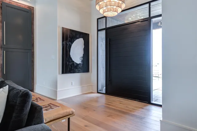 a living room with furniture a lamp and a chandelier