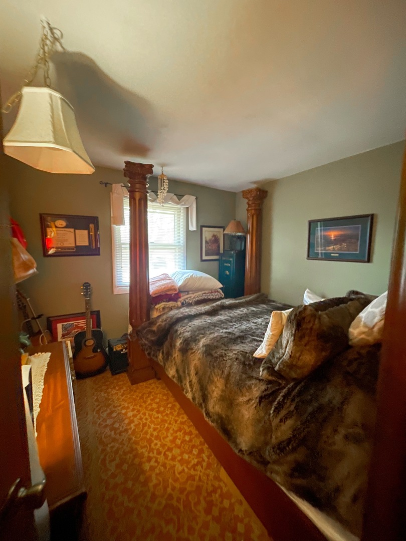 3214 Stieg Road Woodstock, IL 60098 - Photo 12 of 20 a bedroom with a bed and dresser