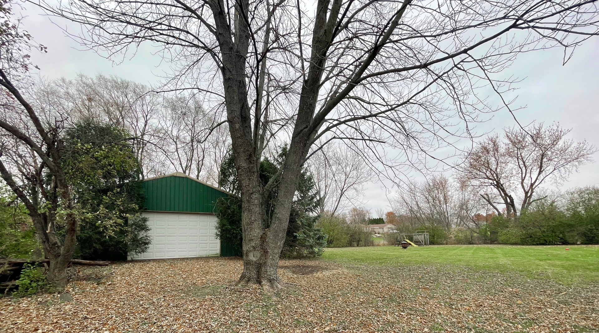 3214 Stieg Road Woodstock, IL 60098 - Photo 19 of 20 a front view of a house with a yard and an trees