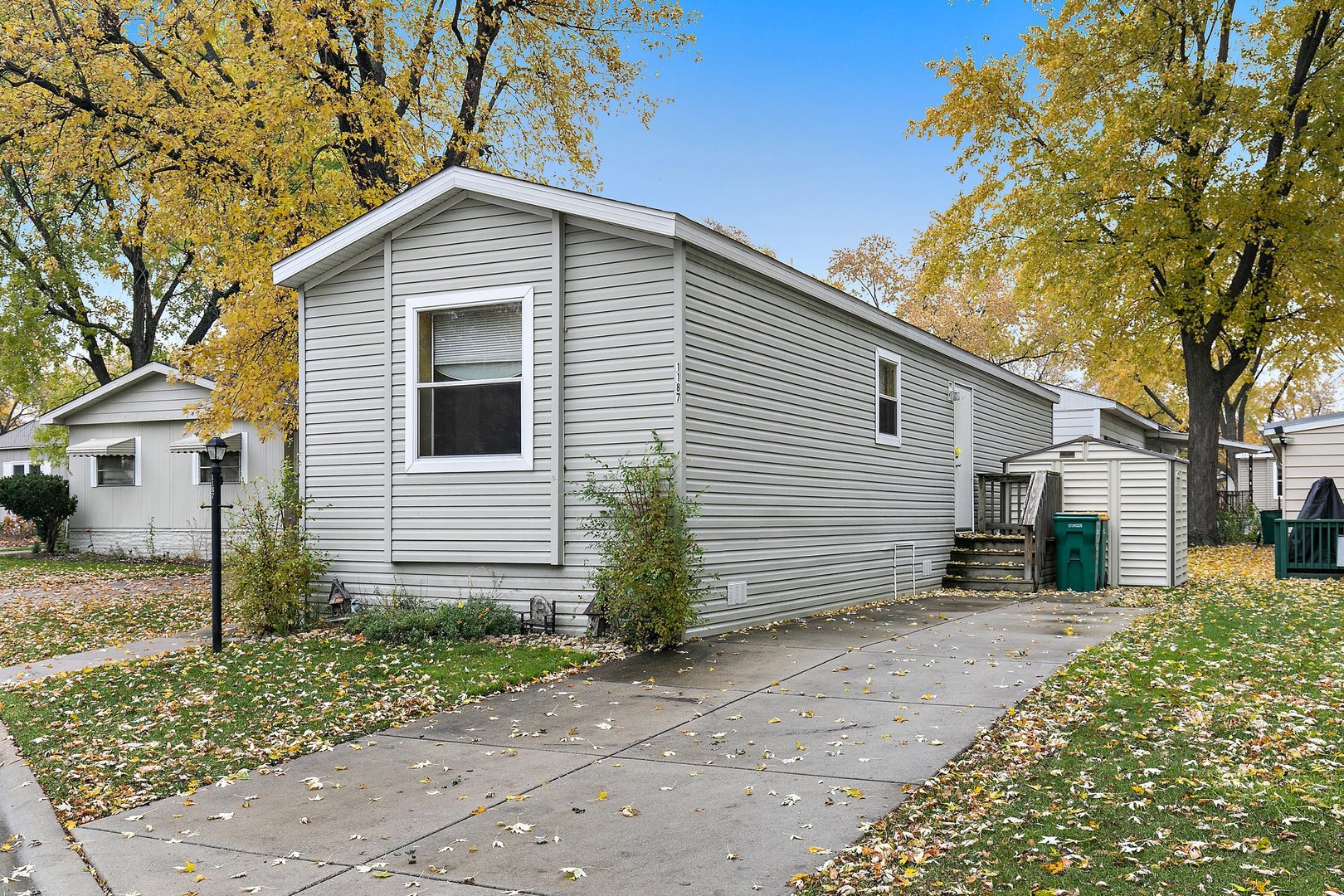 1187 Lakewood Road Elgin, IL 60123 - Photo 3 of 21 a front view of a house with a yard