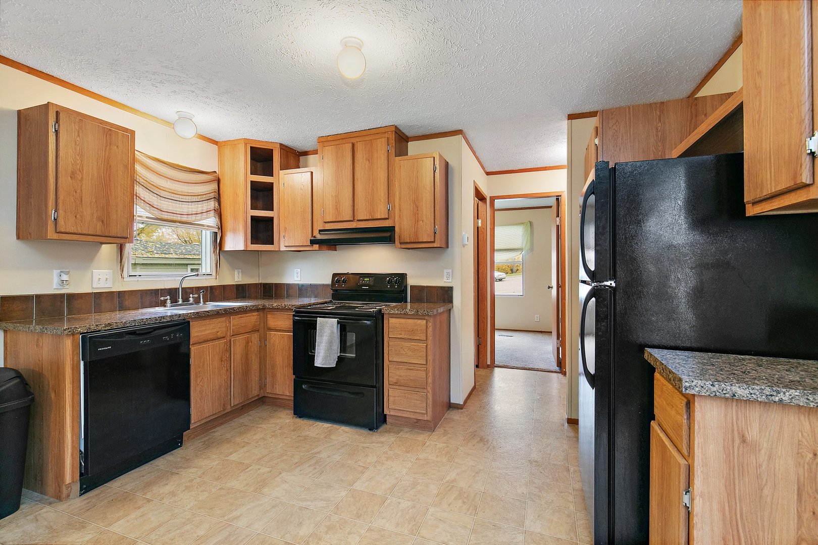 1187 Lakewood Road Elgin, IL 60123 - Photo 6 of 21 a kitchen with stainless steel appliances granite countertop a refrigerator stove and sink