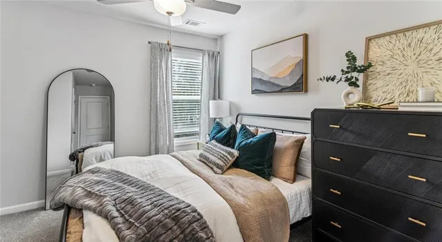 a bedroom with a bed and a painting on the wall