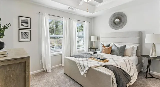 a bed sitting in a bedroom next to a window