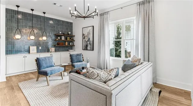 a living room with furniture and a chandelier