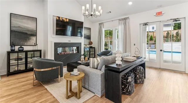 a living room with furniture a fireplace and a flat screen tv
