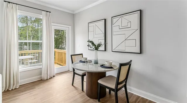 a view of a dining room with furniture and wooden floor