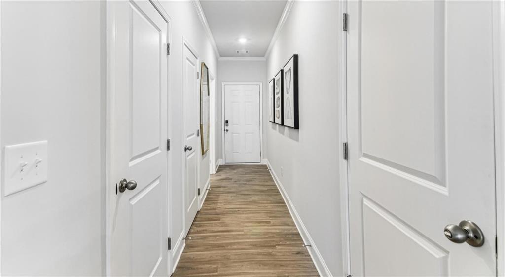 10 Bridgestone Circle, Unit B1 Conyers, GA 30013 - Photo 7 of 25 a view of a hallway with wooden floor and staircase