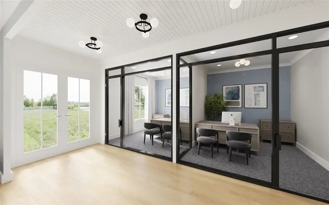 a livingroom with furniture and large windows