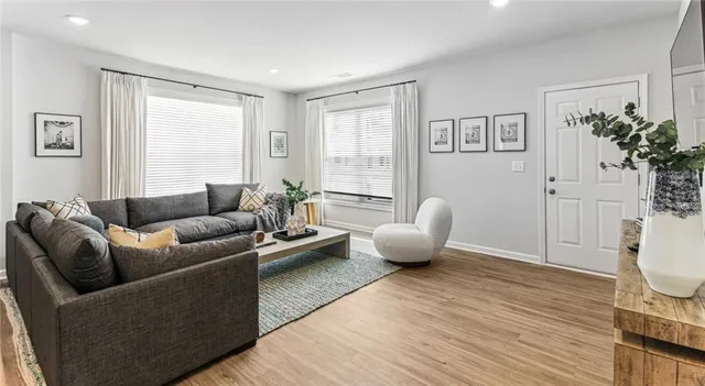 a living room with furniture and a potted plant