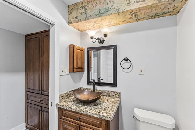 a bathroom with a toilet a sink and mirror