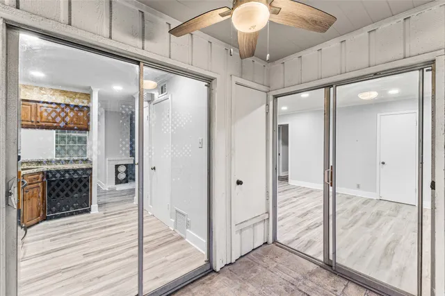 a bathroom with a glass shower door and a mirror